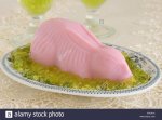 pink-blancmange-in-the-shape-of-a-rabbit-on-green-jelly-grass-E4CNJK.jpg